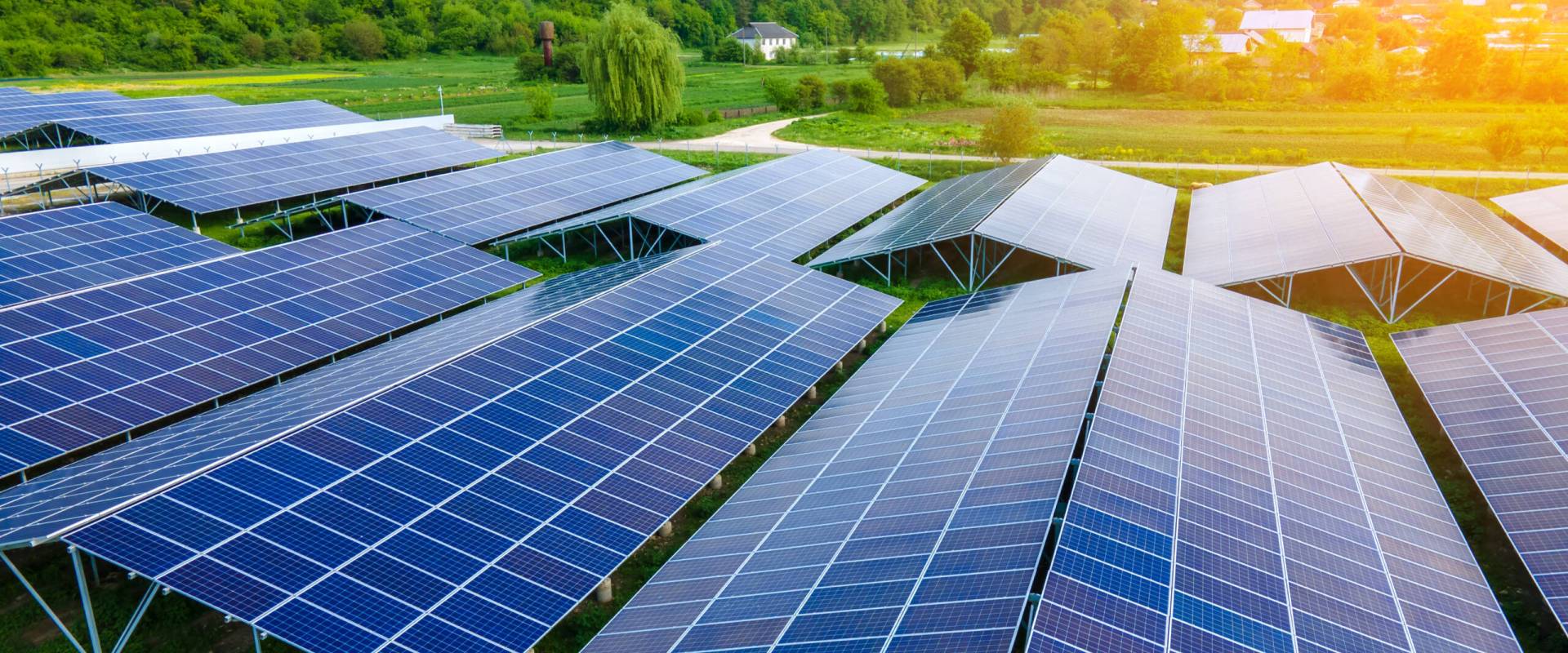 Aerial view of large sustainable electrical power plant with rows of solar photovoltaic panels for producing clean ecological electric energy. Renewable electricity with zero emission concept.
